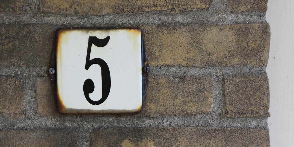 The number five on an address placard