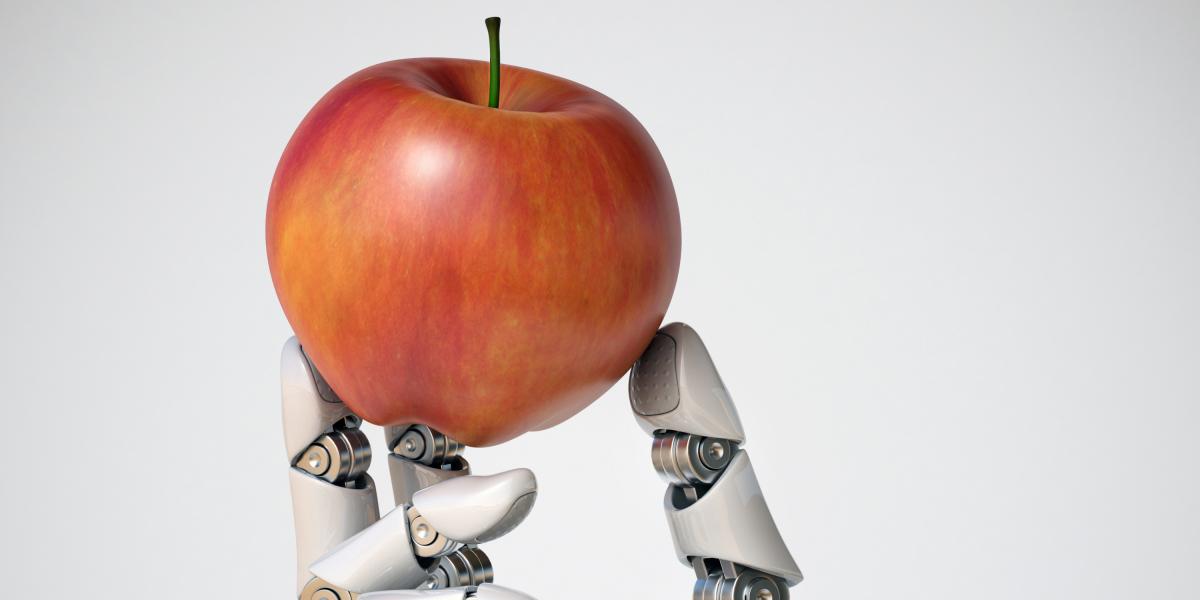 Robot hand holding an apple