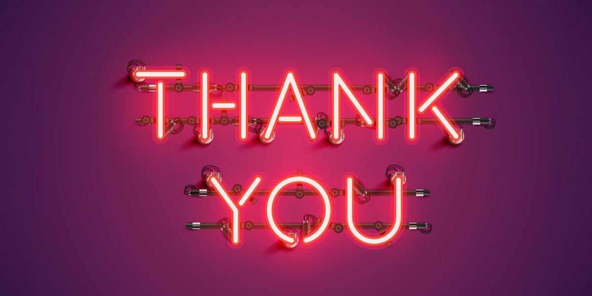 neon "Thank You" sign on purple background