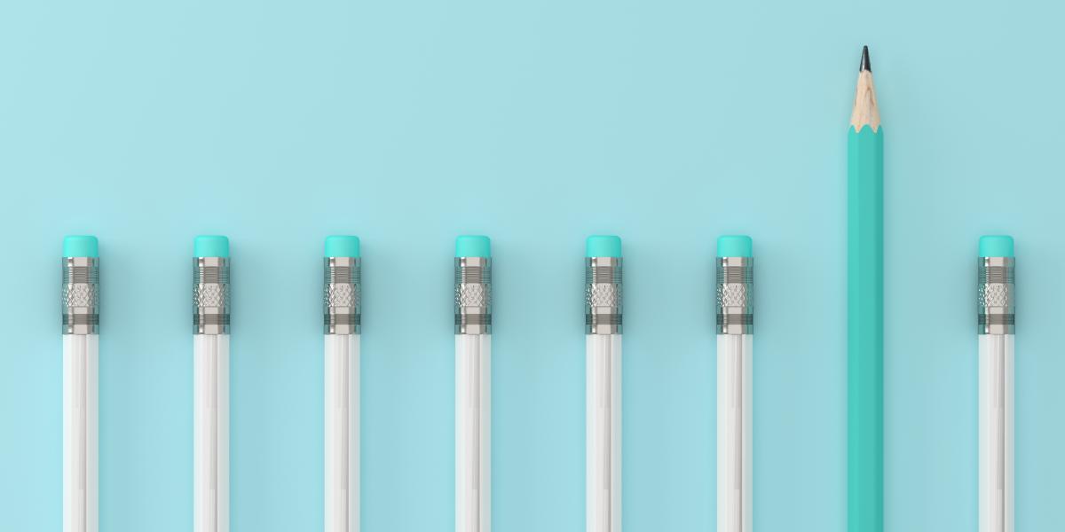 line of pencils on a blue background