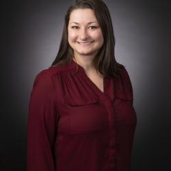 Portrait of a woman with long brown hair smiling