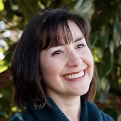 Headshot of a smiling woman outdoors