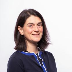 Ashley smiles, wearing a black sweater