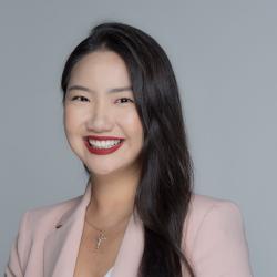 EJ smiles in a pink blazer