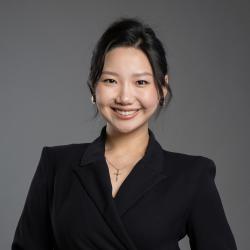 EJ smiles in a black suit