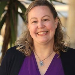 photo of a woman smiling at the camera.