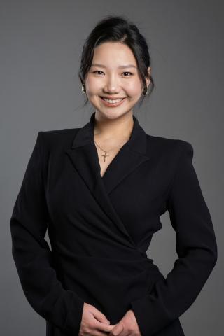 EJ smiles in a black suit