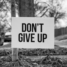 Yard sign that says, Don't Give Up