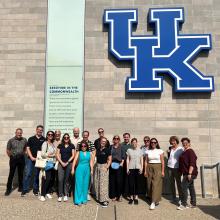group of people standing outside the UK stadium