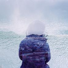 Student in front of water