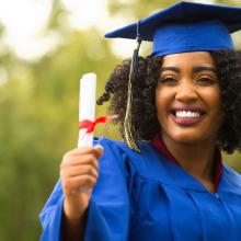 Photo of a graduate holding a diploma
