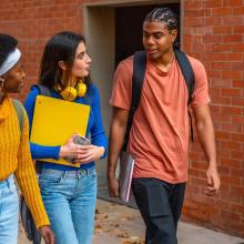 group of young people walking and talking