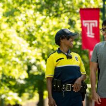 International student and police officer walking on campus