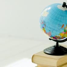 Image of a small globe on top of a stack of books