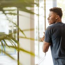 Photo of a student walking out of a building