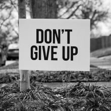 Yard sign that says, Don't Give Up