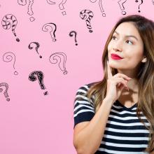 question marks on a pink background with a girl in the foreground