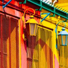 photo of brightly painted building with lamps