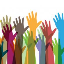 Different colored hands reaching up