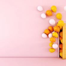 yellow and white balloons emerging from yellow door in pink room