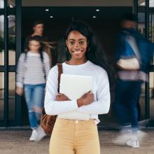 A student standing in front of a doorway