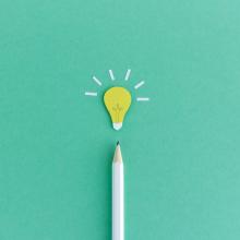 White pencil with a lightbulb above it