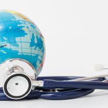 a globe with a stethoscope next to it