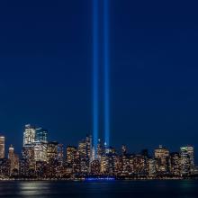 New York City skyline with spotlights where the Twin Towers were.