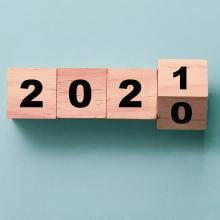 wooden blocks on a blue background turning from 2020 to 2021