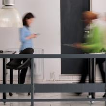 Photo of people moving around in an office