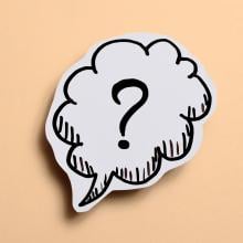 cartoon-style speech bubble with question mark on yellow background