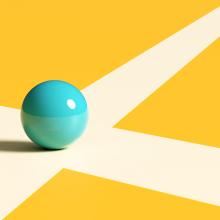 Image of a blue marble sitting at the intersection of two white lines.