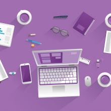 birds-eye view of desk with computer, papers, coffee cups