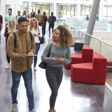 Student walking together in a building on campus