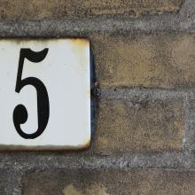 The number five on an address placard