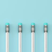 line of pencils on a blue background